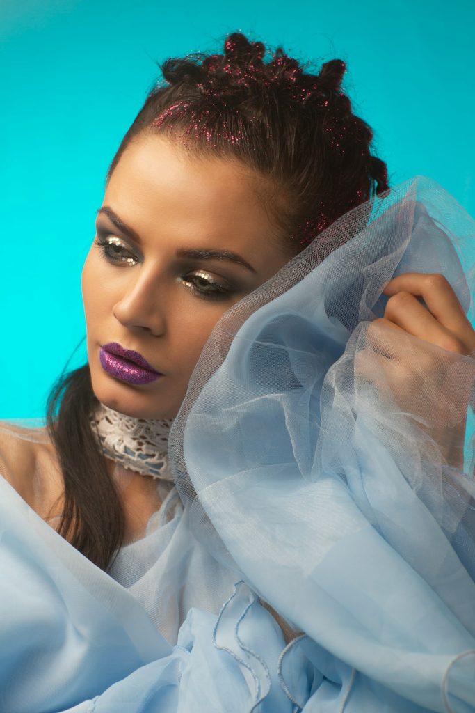 woman-with-glitter-hair-and-purple-lipstick-rk-eelpjsxg